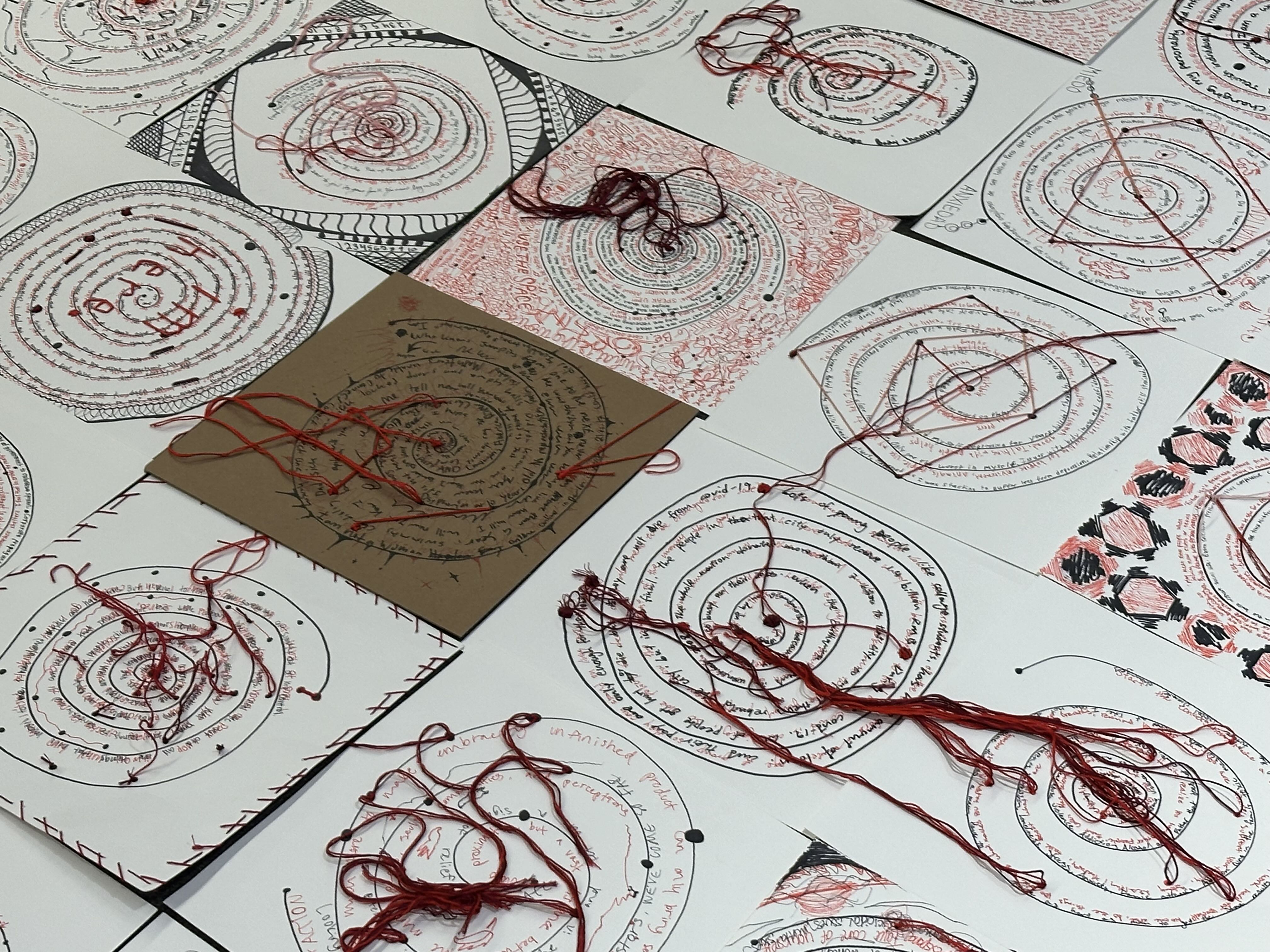 Embroidered paper with marker etchings of circles from previous workshop. 